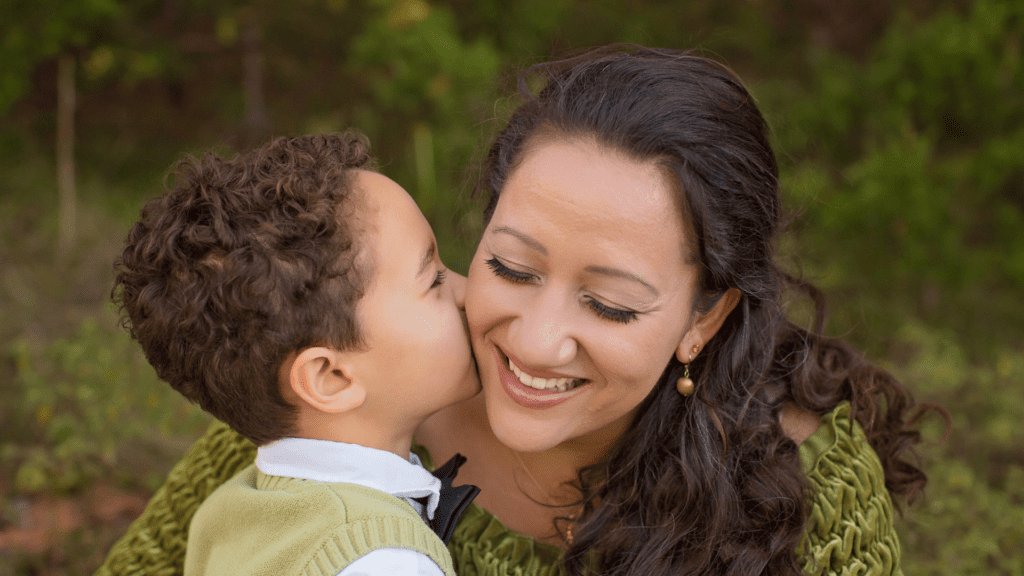 Son kissing mom for discussing oral immunotherapy with his allergist.